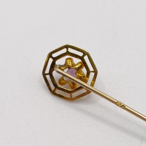 654 - A 20th century yellow coloured metal and purple stone stick pin  Provenance:  From a single owner co... 