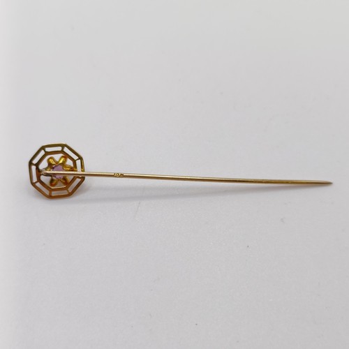 654 - A 20th century yellow coloured metal and purple stone stick pin  Provenance:  From a single owner co... 