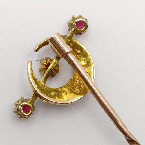 653 - A late 19th/early 20th century yellow metal, seed pearl and red stone stick pin, in the form of a cr... 