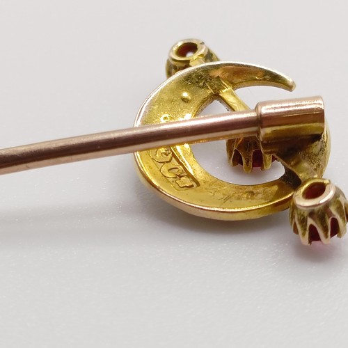 653 - A late 19th/early 20th century yellow metal, seed pearl and red stone stick pin, in the form of a cr... 