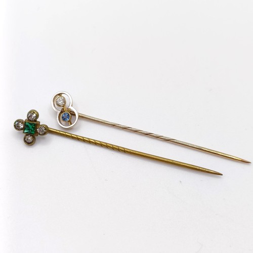 652 - An Art Deco yellow coloured metal, diamond and sapphire stick pin, and a brass and paste stick pin (... 