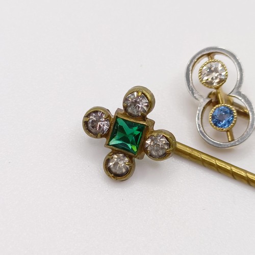 652 - An Art Deco yellow coloured metal, diamond and sapphire stick pin, and a brass and paste stick pin (... 