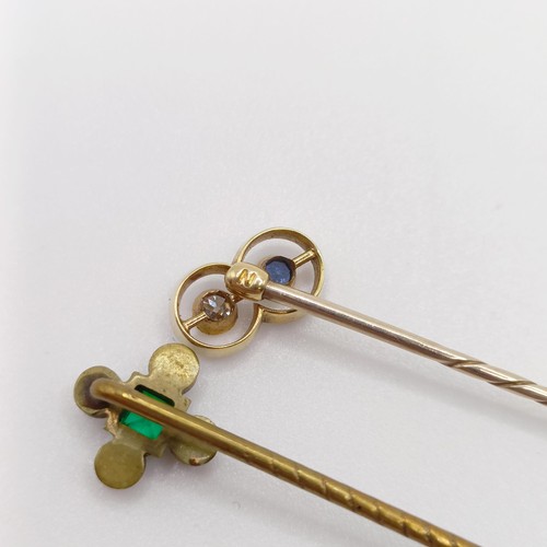 652 - An Art Deco yellow coloured metal, diamond and sapphire stick pin, and a brass and paste stick pin (... 