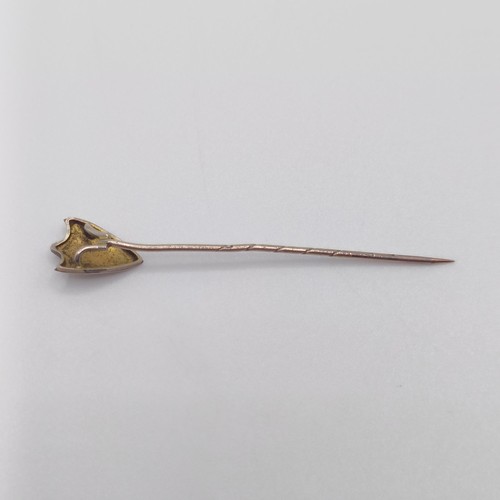 650 - A yellow coloured metal stick pin, in the form of a shield   Provenance:  From a single owner collec... 