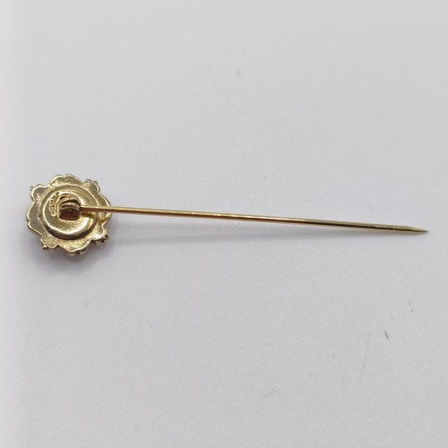 649 - A late 19th/early 20th century yellow coloured metal stick pin, inset with micro-mosaic, decorated f... 