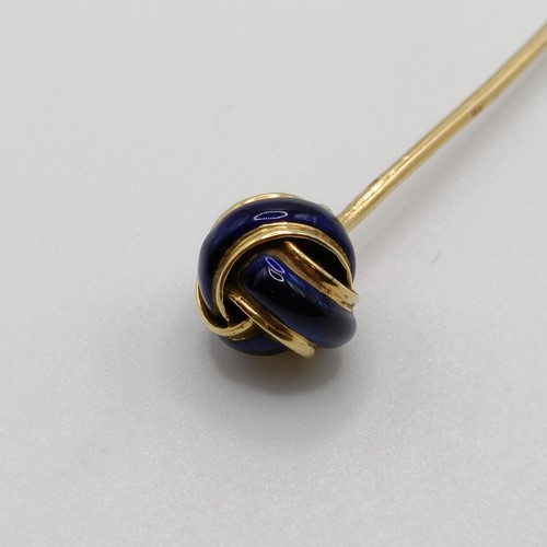 648 - A 20th century yellow coloured metal and blue enamel stick pin, in the form of a knot Provenance:  F... 