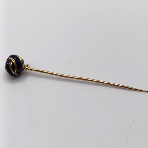 648 - A 20th century yellow coloured metal and blue enamel stick pin, in the form of a knot Provenance:  F... 