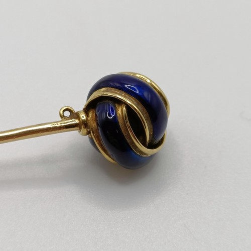 648 - A 20th century yellow coloured metal and blue enamel stick pin, in the form of a knot Provenance:  F... 