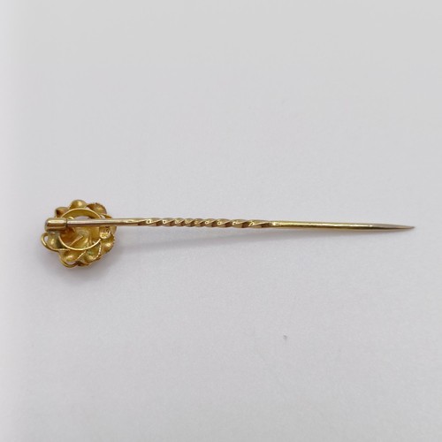 647 - A 20th century yellow coloured metal and ruby stick pin  Provenance:  From a single owner collection... 