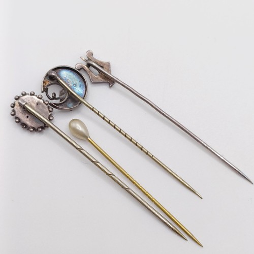 643 - A silver coloured metal stick pin, in the form of a harp, and three other stick pins (4)  Provenance... 