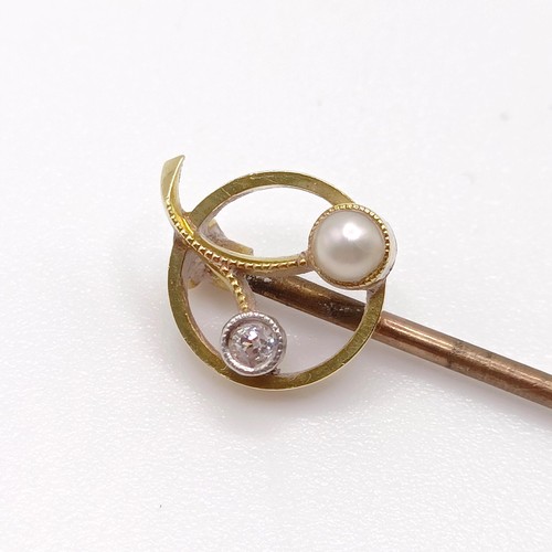 642 - An early 20th century yellow coloured metal, diamond and pearl stick pin   Provenance:  From a singl... 