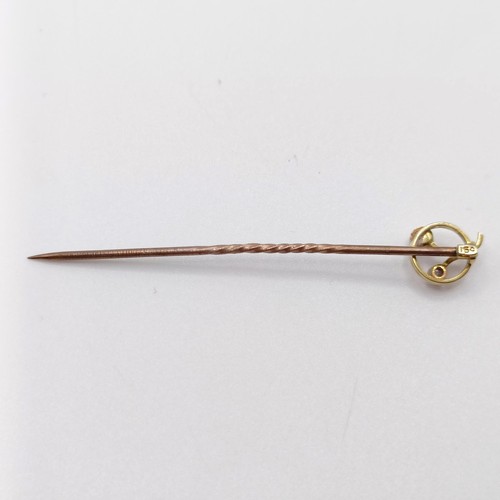 642 - An early 20th century yellow coloured metal, diamond and pearl stick pin   Provenance:  From a singl... 