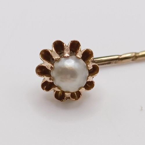 641 - A late 19th/early 20th century yellow metal and pearl stick pin  Provenance:  From a single owner co... 