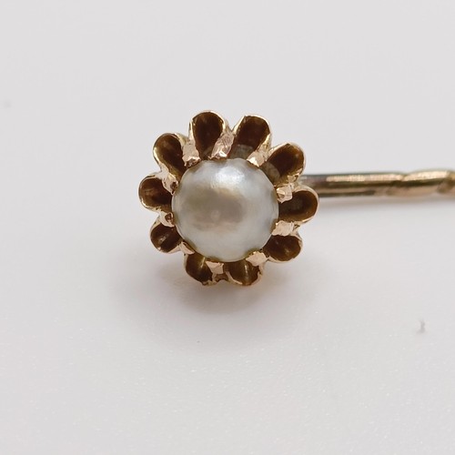 641 - A late 19th/early 20th century yellow metal and pearl stick pin  Provenance:  From a single owner co... 