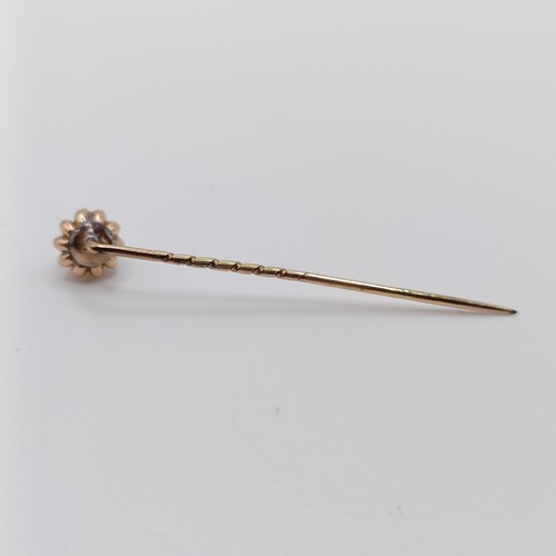 641 - A late 19th/early 20th century yellow metal and pearl stick pin  Provenance:  From a single owner co... 