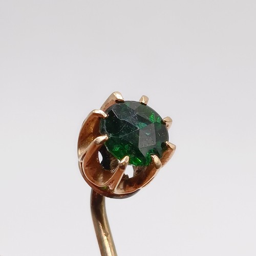 639 - A 20th century yellow coloured metal and green stone stick pin  Provenance:  From a single owner col... 