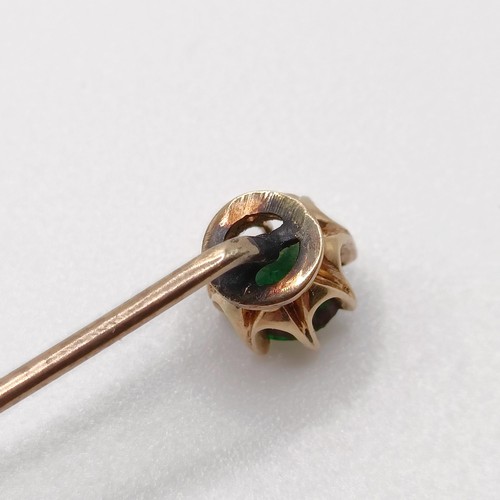 639 - A 20th century yellow coloured metal and green stone stick pin  Provenance:  From a single owner col... 