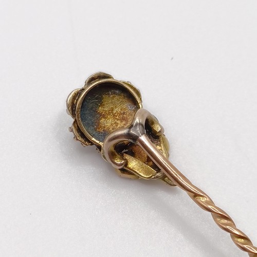 638 - A late 19th/early 20th century yellow coloured metal, pearl and diamond stick pin, in the form of a ... 