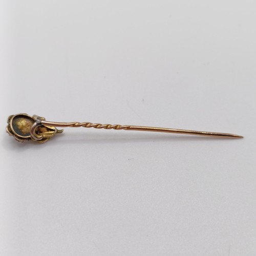 638 - A late 19th/early 20th century yellow coloured metal, pearl and diamond stick pin, in the form of a ... 