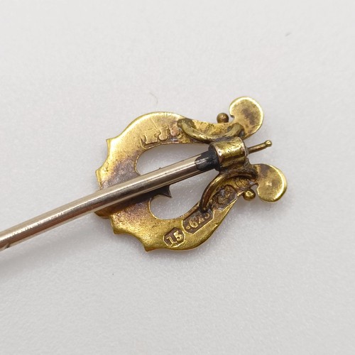 637 - A late 19th/early 20th century yellow coloured metal and seed pearl stick pin, in the form of a harp... 