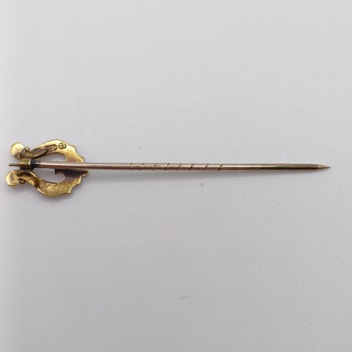 637 - A late 19th/early 20th century yellow coloured metal and seed pearl stick pin, in the form of a harp... 