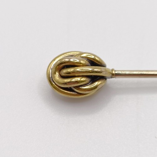 636 - An early 20th century yellow coloured metal stick pin Provenance:  From a single owner collection of... 