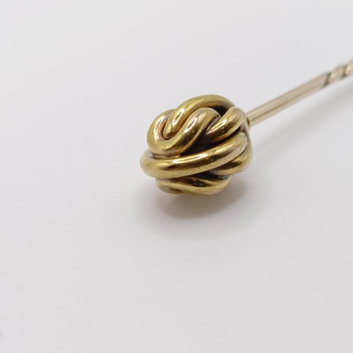 636 - An early 20th century yellow coloured metal stick pin Provenance:  From a single owner collection of... 