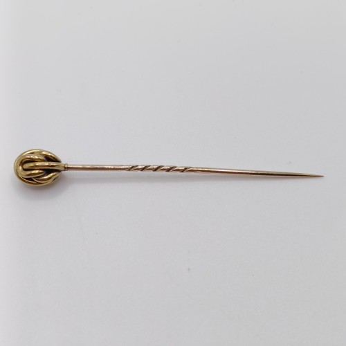 636 - An early 20th century yellow coloured metal stick pin Provenance:  From a single owner collection of... 