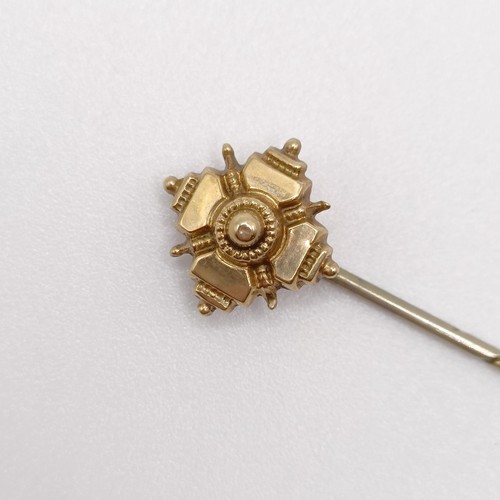 635 - A late 19th/early 20th century yellow coloured metal stick pin  Provenance:  From a single owner col... 