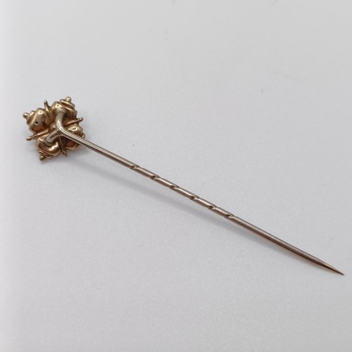 635 - A late 19th/early 20th century yellow coloured metal stick pin  Provenance:  From a single owner col... 