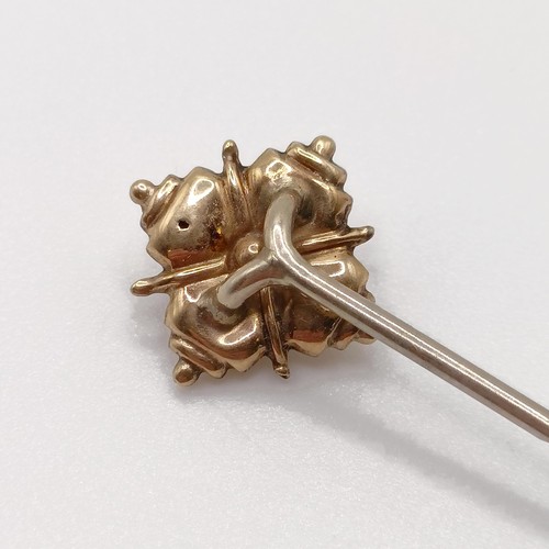 635 - A late 19th/early 20th century yellow coloured metal stick pin  Provenance:  From a single owner col... 