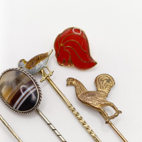 633 - A gilt metal stick pin, in the form of a cockerel, three other stick pins and a badge (5) Provenance... 