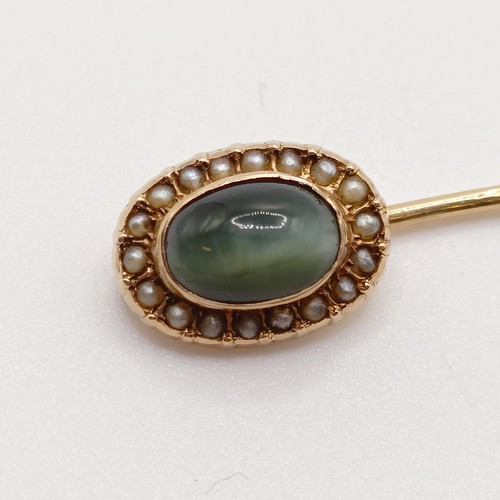 632 - A late 19th/early 20th century yellow metal, tiger's eye and seed pearl stick pin  Provenance:  From... 