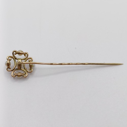 631 - A late 19th/early 20th century yellow metal and pearl stick pin  Provenance:  From a single owner co... 