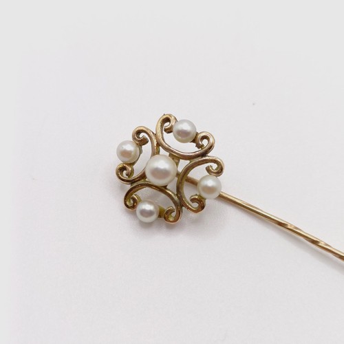 631 - A late 19th/early 20th century yellow metal and pearl stick pin  Provenance:  From a single owner co... 