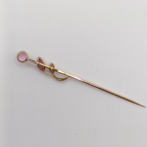 628 - A yellow coloured metal and pink stone stick pin  Provenance:  From a single owner collection of Vic... 