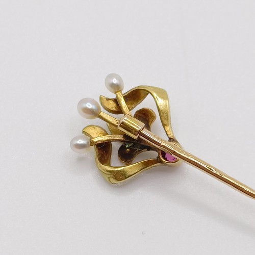 626 - An Art Nouveau yellow coloured metal, green enamel, ruby and pearl stick pin  Provenance:  From a si... 