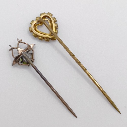 623 - A silver coloured metal, seed pearl and green stone stick pin, in the form of a fly, and a white and... 