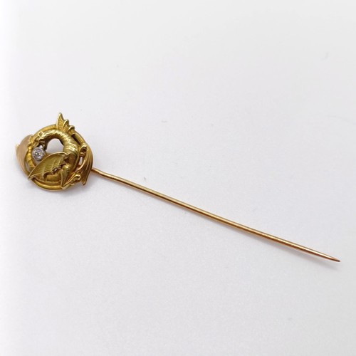 622 - A late 19th/early 20th century yellow coloured metal and diamond stick pin, in the form of a dragon ... 