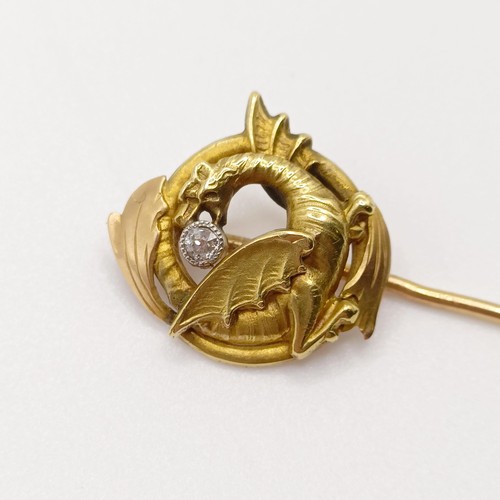 622 - A late 19th/early 20th century yellow coloured metal and diamond stick pin, in the form of a dragon ... 