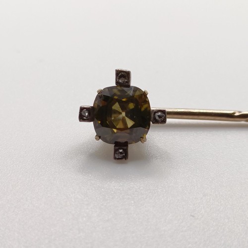 619 - A late 19th/early 20th century yellow coloured metal and yellow stone stick pin  Provenance:  From a... 