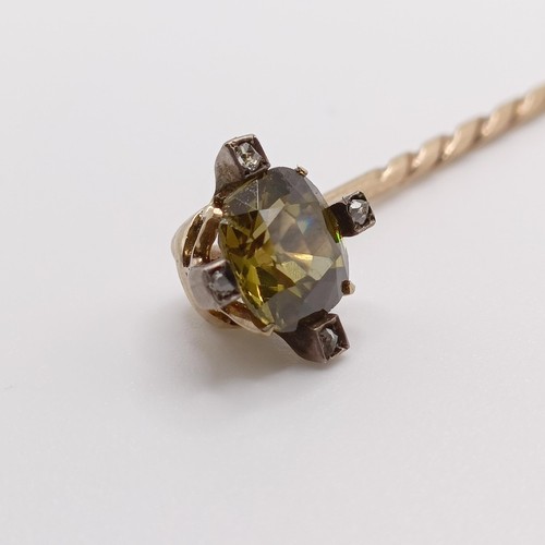 619 - A late 19th/early 20th century yellow coloured metal and yellow stone stick pin  Provenance:  From a... 