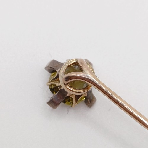 619 - A late 19th/early 20th century yellow coloured metal and yellow stone stick pin  Provenance:  From a... 