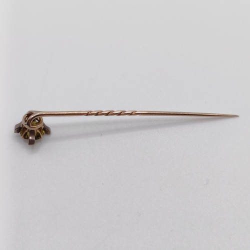 619 - A late 19th/early 20th century yellow coloured metal and yellow stone stick pin  Provenance:  From a... 