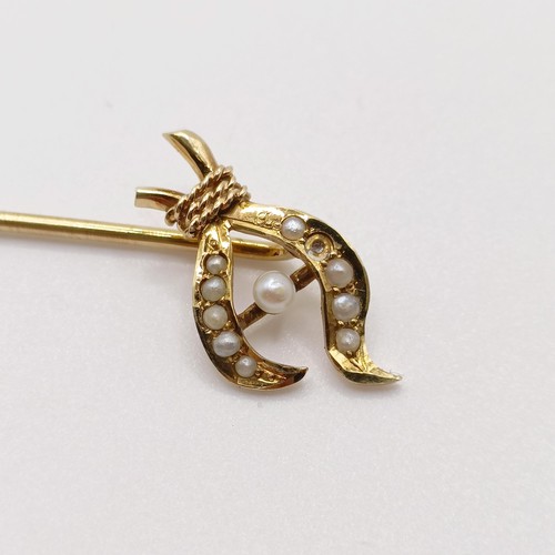 617 - A late 19th/early 20th century yellow metal and seed pearl stick pin  Provenance:  From a single own... 