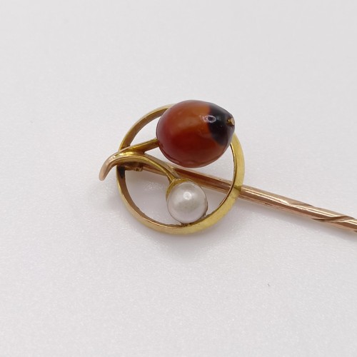 616 - A late 19th/early 20th century yellow metal, cultured pearl and hardstone stick pin  Provenance:  Fr... 