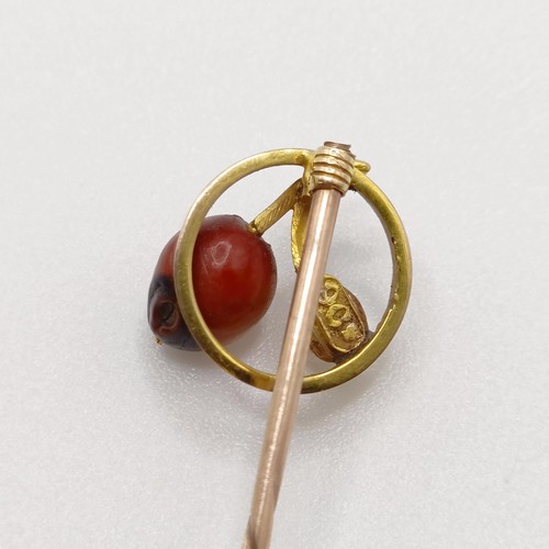 616 - A late 19th/early 20th century yellow metal, cultured pearl and hardstone stick pin  Provenance:  Fr... 