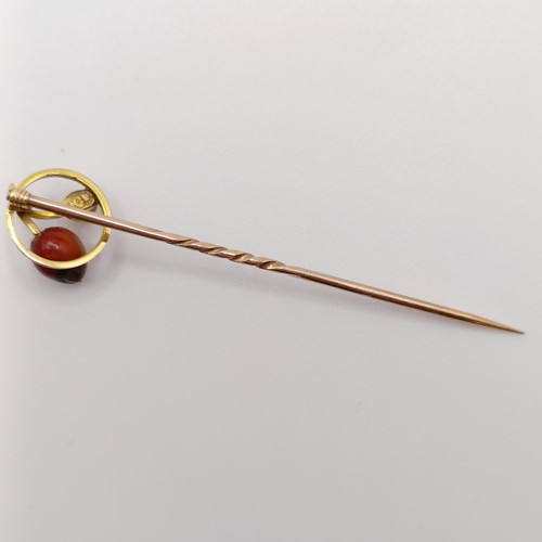 616 - A late 19th/early 20th century yellow metal, cultured pearl and hardstone stick pin  Provenance:  Fr... 