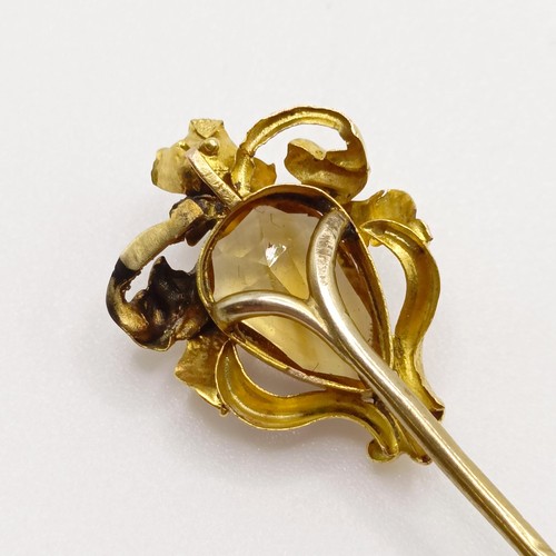 615 - An Art Nouveau style yellow metal and brown stone stick pin Provenance:  From a single owner collect... 