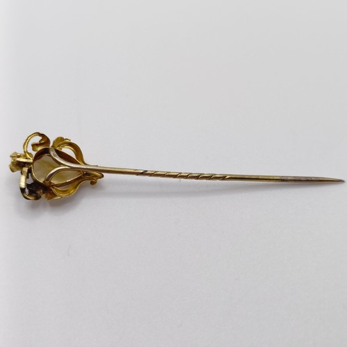 615 - An Art Nouveau style yellow metal and brown stone stick pin Provenance:  From a single owner collect... 